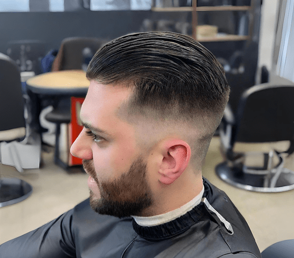 Man with slicked-back hair and beard.